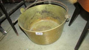 A large heavy brass jam pan.