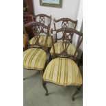 A set of four Victorian mahogany dining chairs.