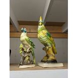 Two ceramic parrots.