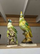 Two ceramic parrots.