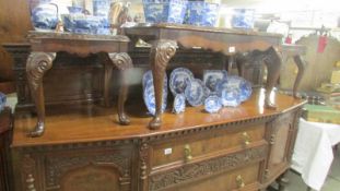 A mahogany glass topped coffee table with two matching smaller tables.