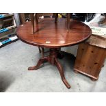 A dark stained pine circular kitchen table, 90 cm diameter, 77 cm high.