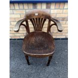 An early 1900's bentwood carver chair, carved detail to seat, turned legs, label to base.