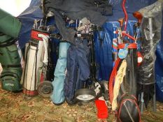 A large quantity of golf bags and clubs.