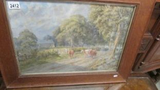 A framed and glazed watercolour rural with cattle, signed and dated 1921.