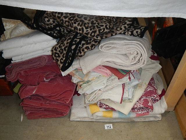 A quantity of bedspreads, curtains etc.