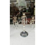 A silver plate candelabra with glass droppers.
