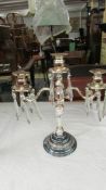 A silver plate candelabra with glass droppers.