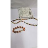 A mixed agate necklace and a bracelet with amber coloured stones.