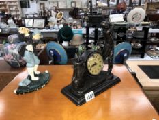 A cast iron door stop of a golfer and a Juliana collection clock figure of a golfer