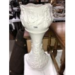 A white pottery jardiniere on stand (chips to top of stand)