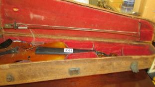 An old cased violin with bow.