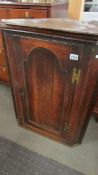 An oak corner cupboard.