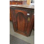 An oak corner cupboard.