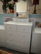 A white 2 over 3 chest of drawers.