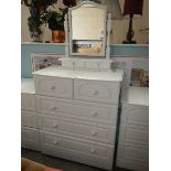 A white 2 over 3 chest of drawers.