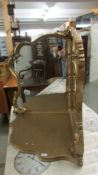 A free standing gilt framed corner mirror.