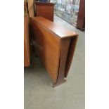 A good quality teak drop side table.