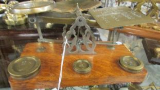 A set of brass postal scales with weights.