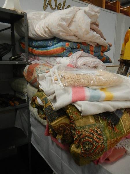 A large lot of bedding, quilts etc.