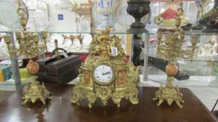 A French ormolu/brass clock garniture,