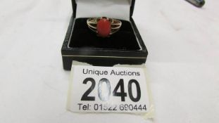 An early 20th century coral set single stone ring in 9ct gold, size R.