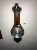 An Edwardian carved oak barometer (length 51cm)