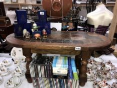 A heavy oak coffee table with slate centre