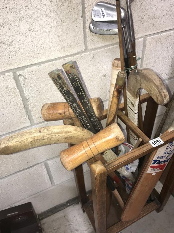 A 1930's oak stitch stand & sports equipment including golf clubs & cricket bats etc. - Image 2 of 3