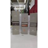 Three bottles of Auchentoshan triple distilled single malt scotch whisky.