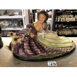 A large vintage painted plaster figurine of a lady in crinoline dress with dog.
