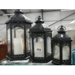 A set of three outside candle lanterns.