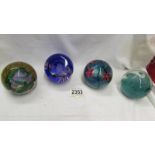 Four Caithness glass paperweights.