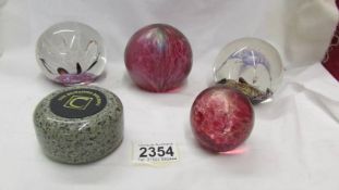 Two Selkirk glass paperweights, 2 others and a granite curling stone paperweight.