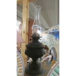 A Victorian oil lamp with chimney.