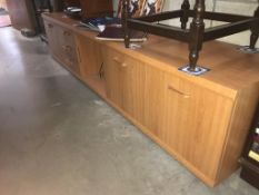 A long low teak effect sideboard (223cm x 46cm x 48cm)