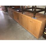 A long low teak effect sideboard (223cm x 46cm x 48cm)