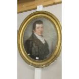 A gilt framed oval portrait of a gentleman (19th century).