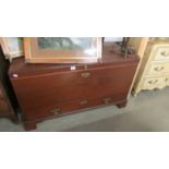 A large mahogany trunk with drawer.