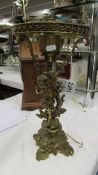 A Victorian solid brass cherub table lamp base (needs re-wiring).