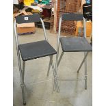 A pair of folding work bench chairs.