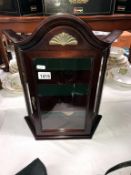 A small mahogany display cabinet with glass front