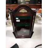 A small mahogany display cabinet with glass front