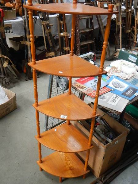 A five shelf oak corner unit.