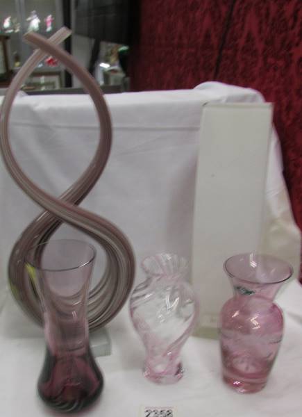 A Caithness glass vase, three others and another glass item.
