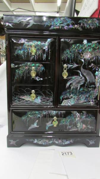 A modern jewellery cabinet inlaid with mother of pearl.