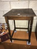 A carved oak occasional table.