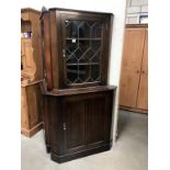 A dark oak corner cabinet with leaded glass door, 90 cm wide x 179 cm high.