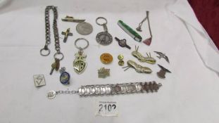 A mixed lot including badges, watch chain, key rings etc.
