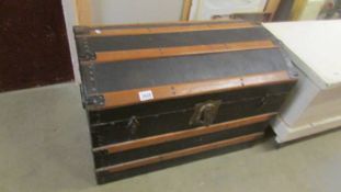 A dome top cabin trunk in good condition.